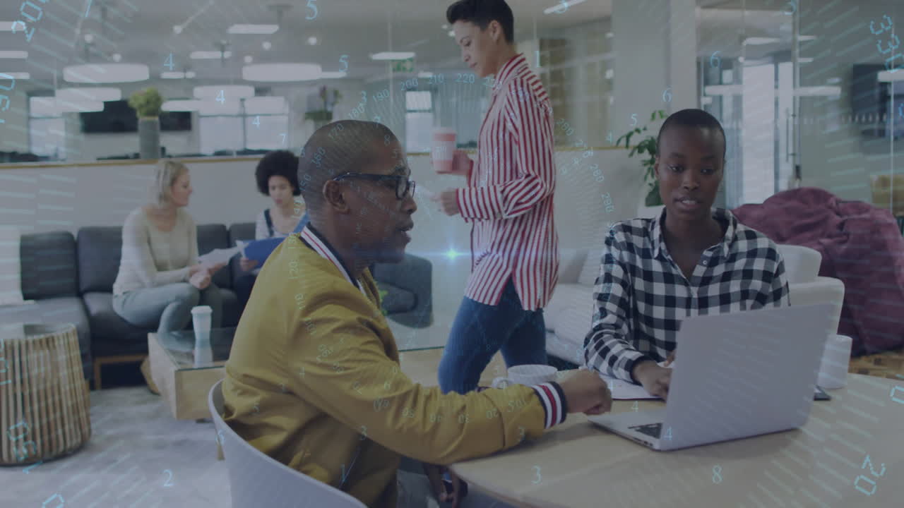 Diverse colleagues collaborating at office with digital data animation overlay