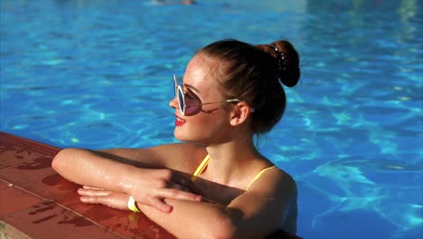 teenage girl relaxing in a swimming pool