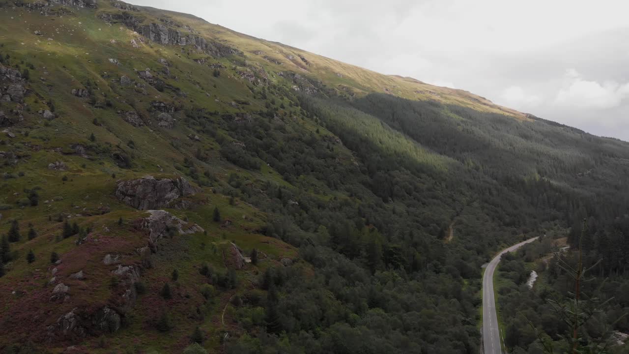 Aerial footage over the Rest and Be Thankful pass in the Arrochar Alps. The Arrochar Alps are a group of mountains located around the head of Loch Long, Loch Fyne, and Loch Goil, Scotland, UK