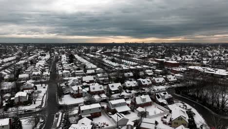 an aerial view of a suburban neighborhood after it snowed