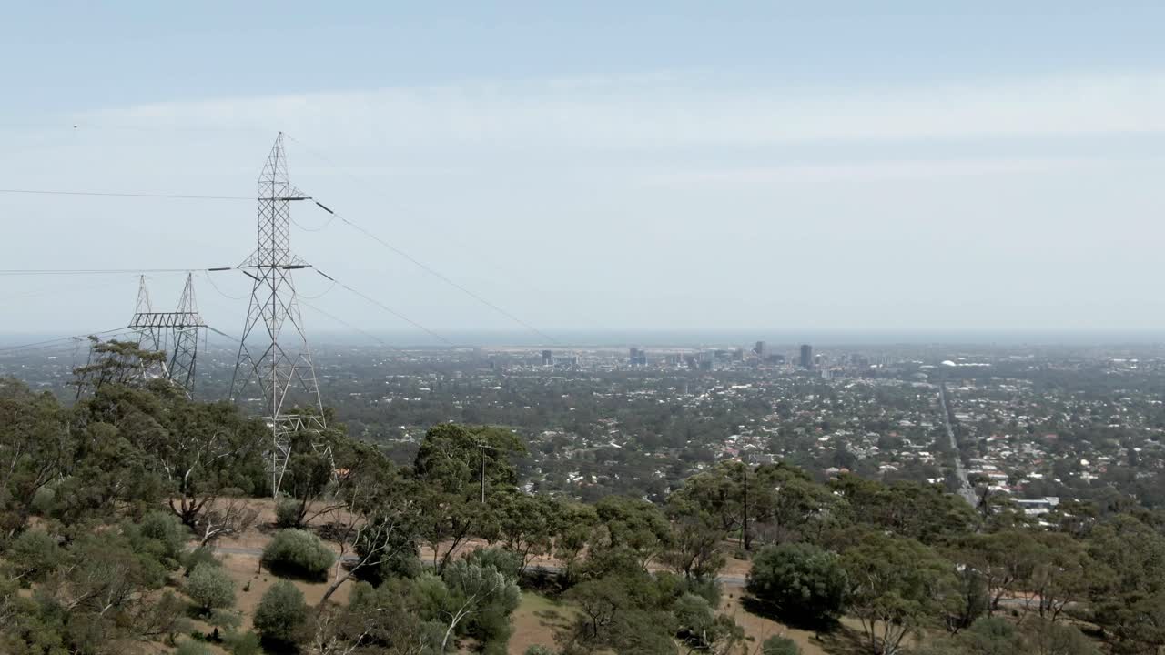 Cars Traveling On The Road On Hill With Adelaide Cityscape At Background In Australia