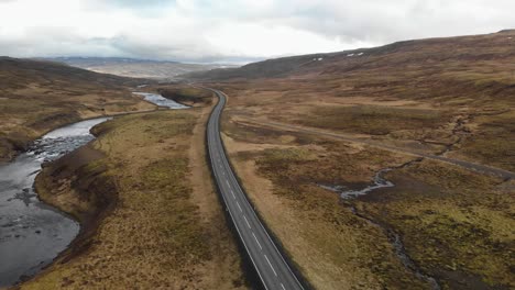 aerial footage following a highway that leads through the mountains of iceland