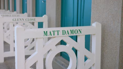 american actor matt damon's name sign on wooden beach huts and boardwalk in deauville, normandy france