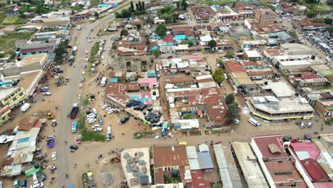 Aerial-view-of-cars-and-people-at-a-Open-Air-Market,-in-Africa---reverse,-drone-shot