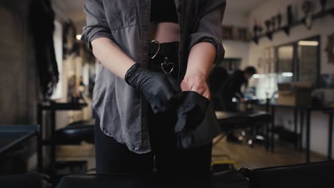 close up of caucasian woman preparing to start tattooing customer.