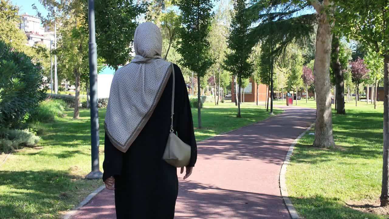 Woman in hijab walking in the park