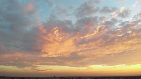 stunning sunset over cityscape with dramatic clouds