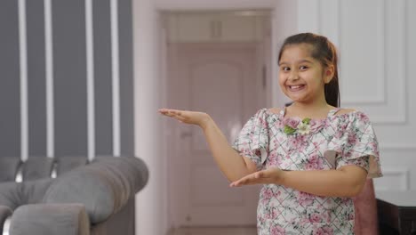 Happy-Indian-kid-pointing-at-the-blank-for-Copyspace