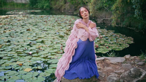 romantic lady sitting pond at green park. mesmerizing woman posing forest lake