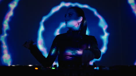 a female dj performing at a nightclub