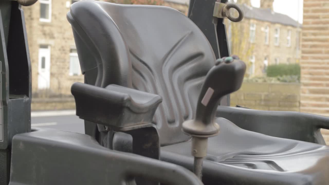 Industrial plant machinery driver seat panning shot