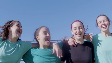 four active teenaged girls cheering up and jumping with joy