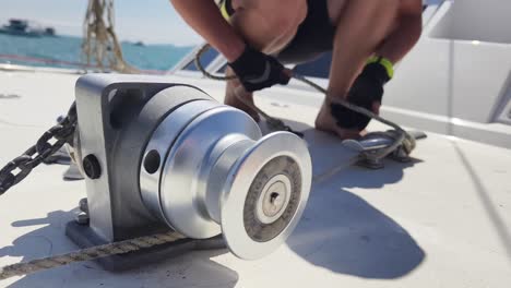 sailor adjusting mooring lines on a catamaran