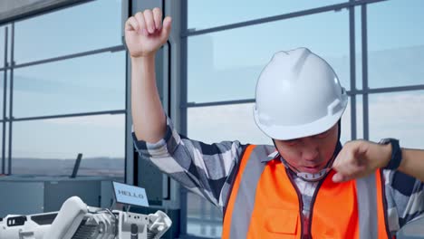 happy engineer celebrating success in modern industrial workplace