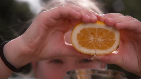 Young girl squeezes lemon halve to make lemonade two hand 1000 fps Phantom