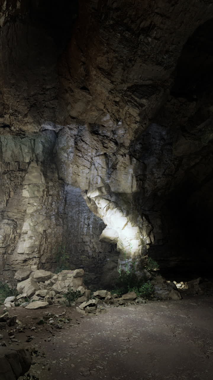 Exploring the dark depths of an underground cavern illuminated by lights