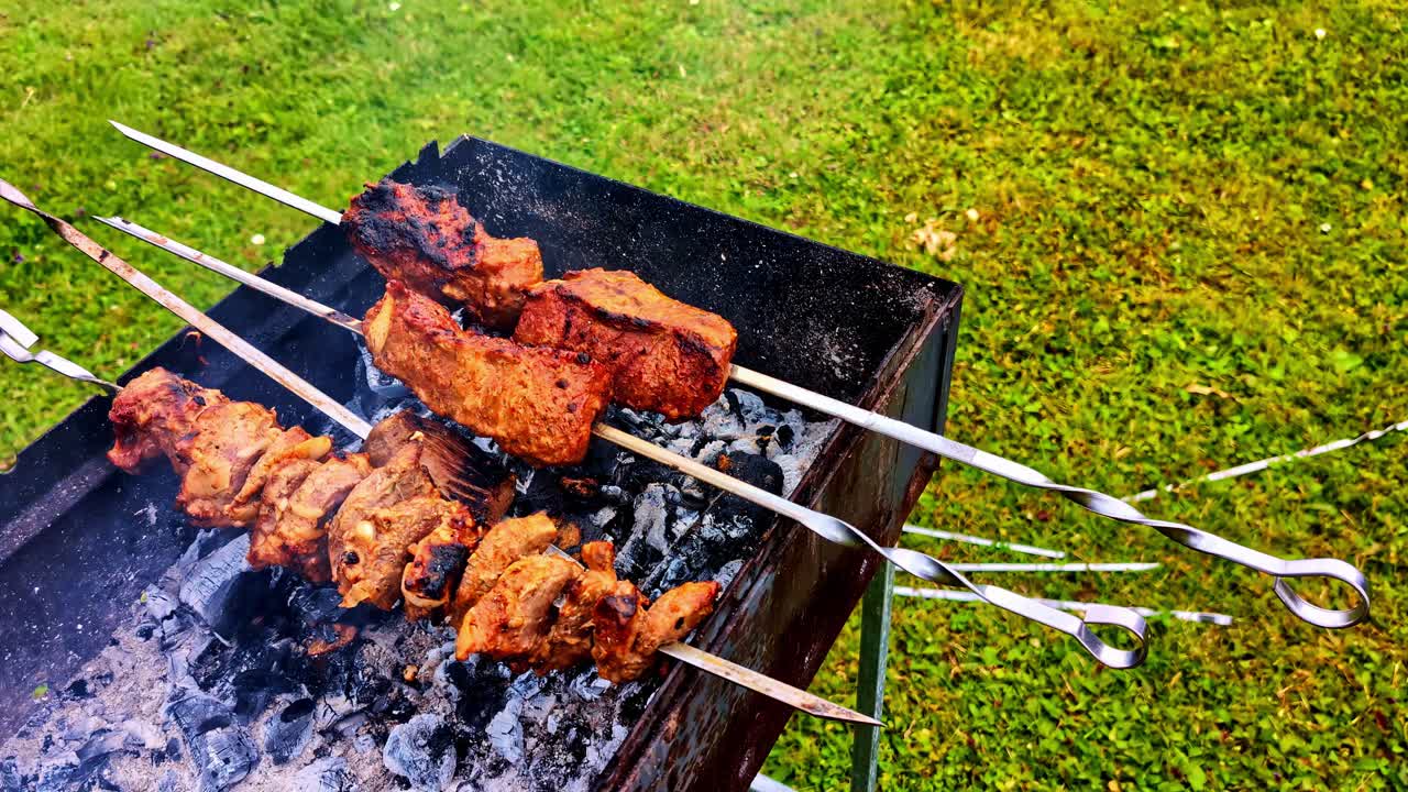 Meat being grilled at a garden party. Slow-motion cinematic camera movement. Close-up shot of food