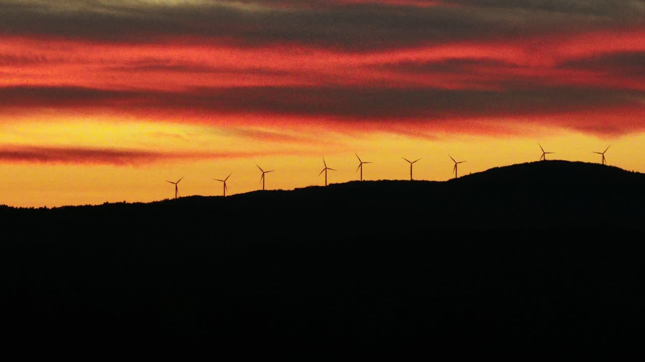 Maine Wind Farm Silhouette Against Vibrant Orange Sunset Sky