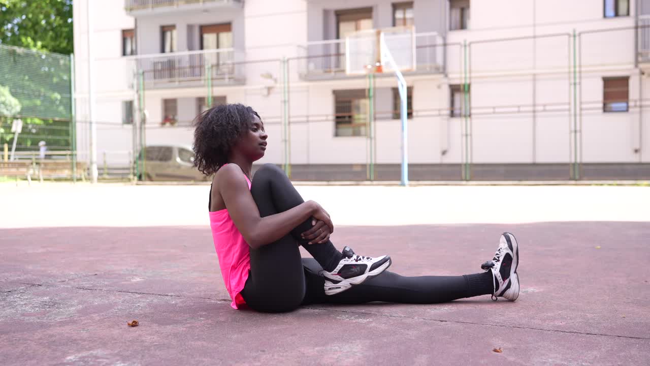 Woman Doing Stretching Exercise on Court