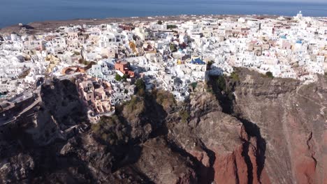 scenic view over the famous village of oia at the island santorini, greece - aerial drone shot