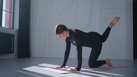 woman doing yoga pose in gym