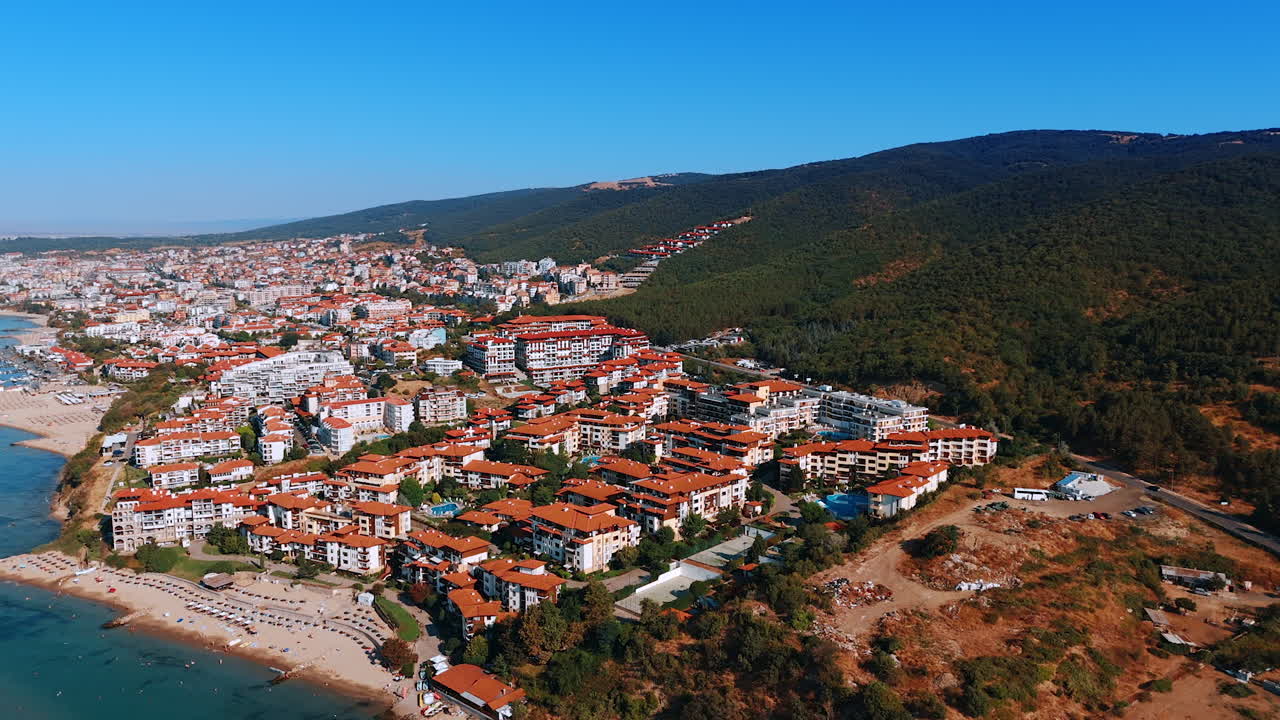 Aerial view of Sveti Vlas resort town and Black Sea coast in Bulgaria. Panoramic aerial view of the town of Sveti Vlas with red-roof houses, hotels, and coastline along the Black Sea