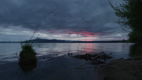 red sunset through clouds from lake rotorua.