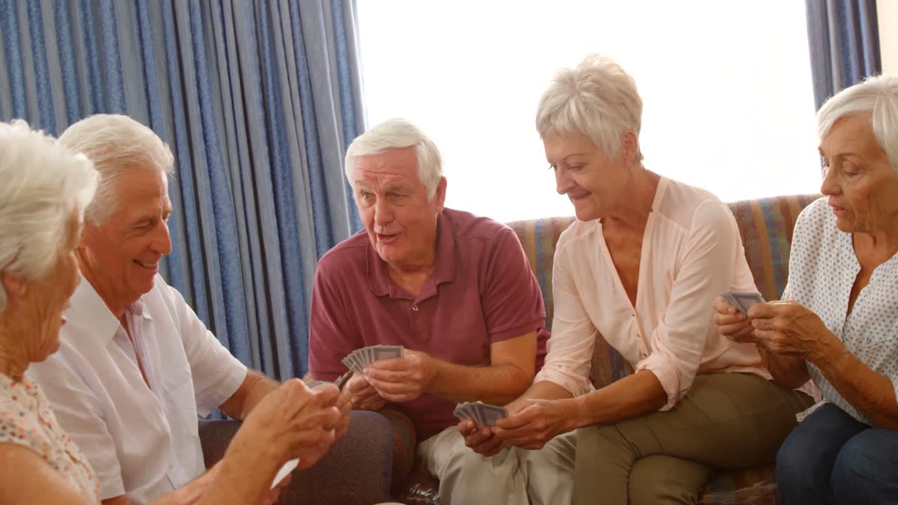 노인 친구 들 의 그룹 이 카드 를 치고 있다