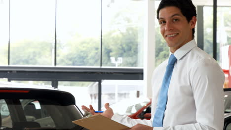 man in a suit signing a document