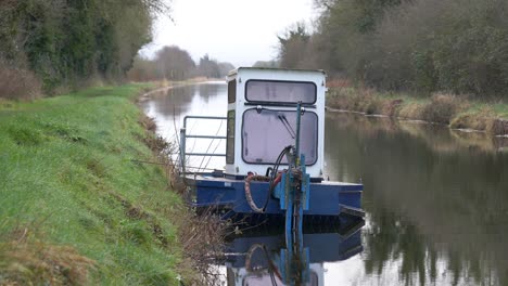 Workboat-Dock-On-The-Shore-Of-Grand-Canal-In-County-Kildare,-Ireland---Waterways-Ireland-Service-Company