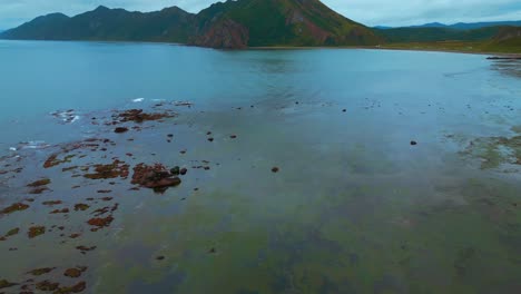 coastal landscape with rocky shore and mountains