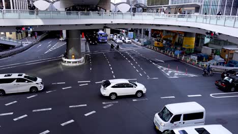 vehicles navigating through a bustling city crossroad