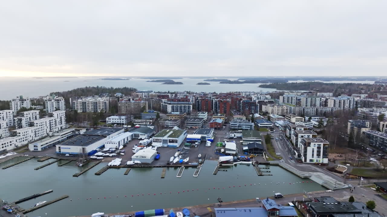 Aerial tracking shot of the cityscape of Lauttasaari, winter evening in Helsinki