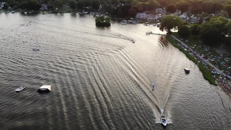 as the sun is setting over a small town in western wisconsin, waterskier are practicing