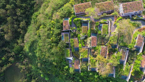 complex of villas with private pools on mountain slope with rural view of tropical nature at maua hotel and resort in nusa penida klungkung regency, aerial top down