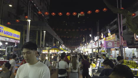 slow motion pov walking down jalan alor food street with famous stalls in kuala lumpur, malaysia