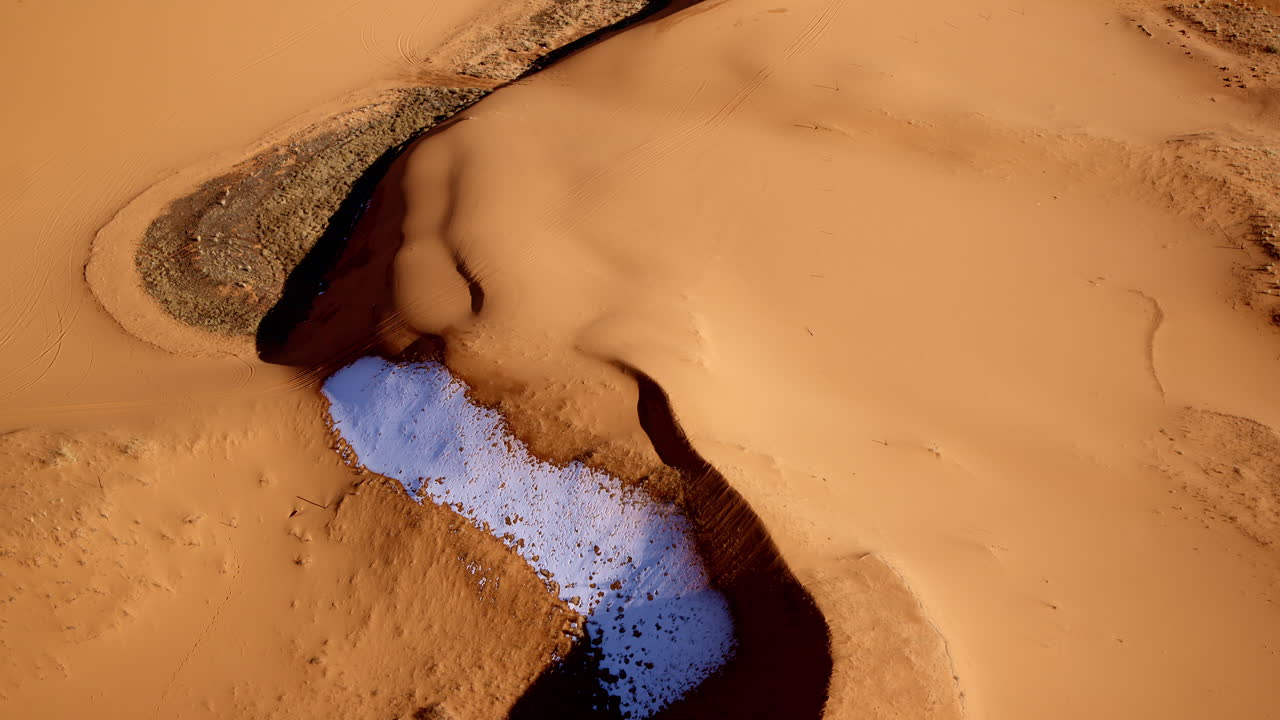 Aerial shot of the pink dunes, where wind-sculpted lines create surreal natural art.
