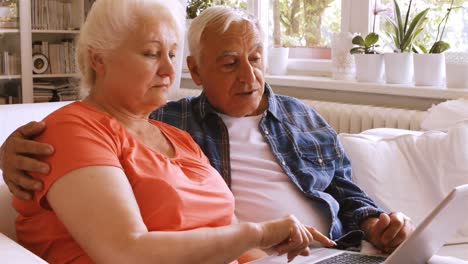 senior couple using laptop