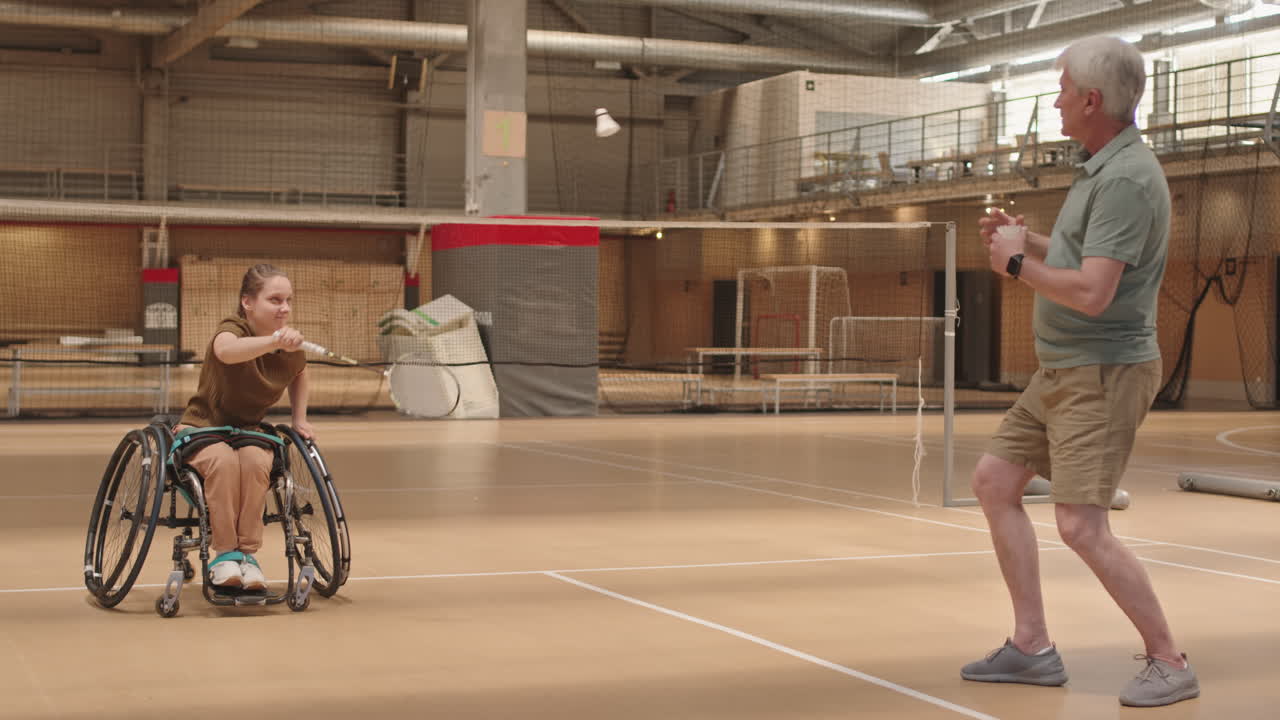 Coach Teaching Girl Hitting Badminton Serve