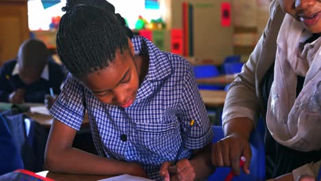 teacher helping schoolchildren in a lesson at a township school 4k