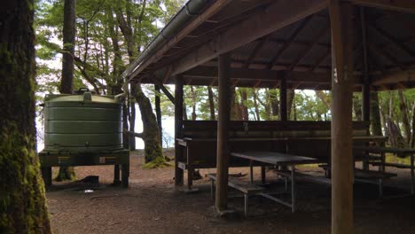 Slider,-forest-shelter-and-water-tank,-Fiordland,-Kepler-Track-New-Zealand