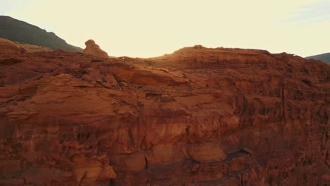 Close-up-of-orange-rock-mountain-at-sunset