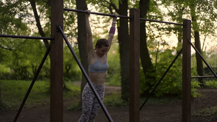 Woman exercising on pull-up bar