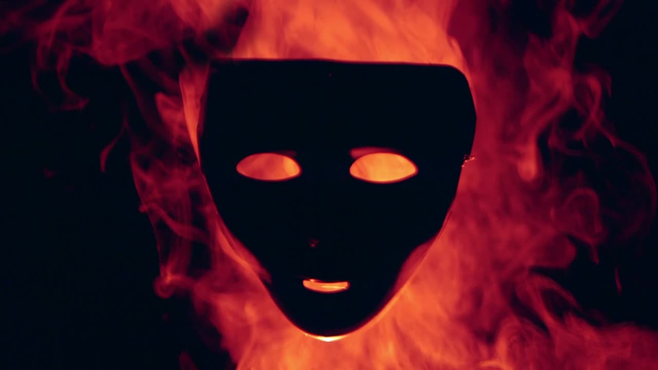 Human mask in the red fire