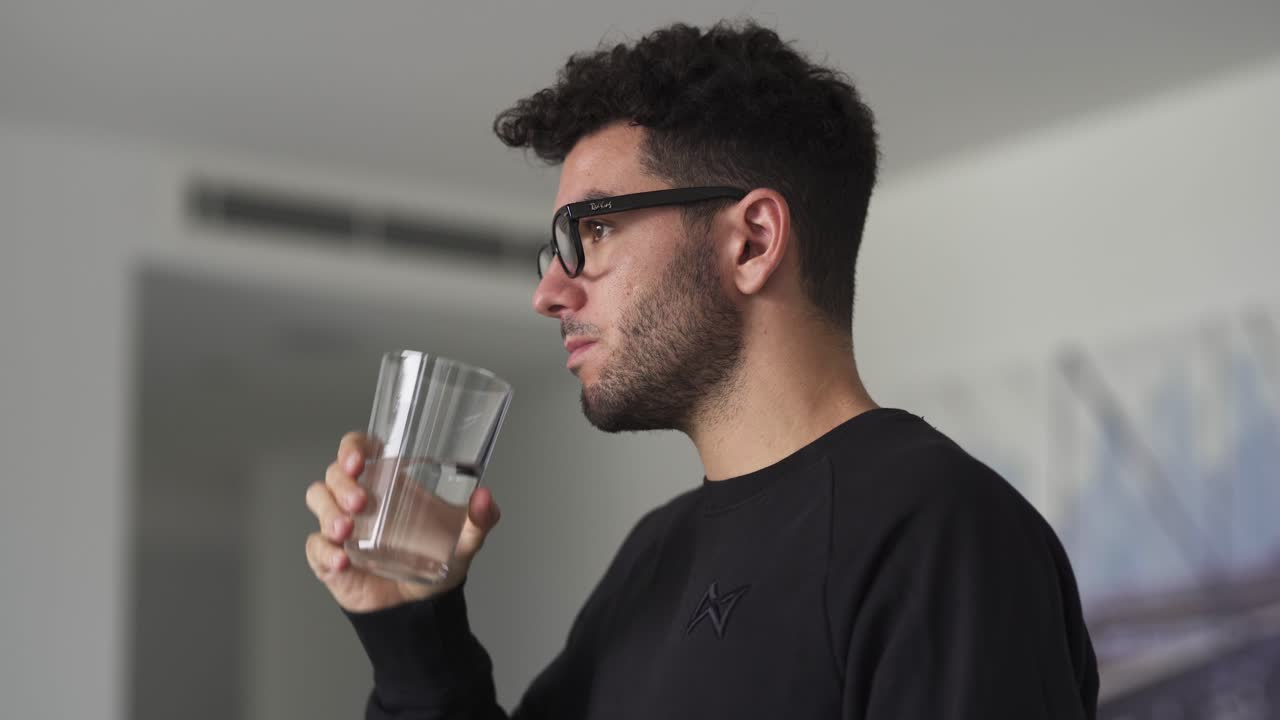 Caucasian man drinking a glass of water