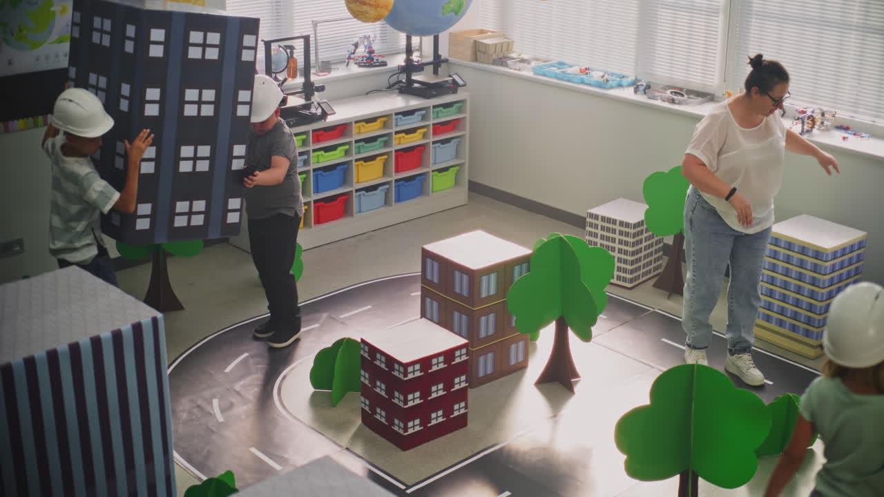 Smart Young Kids in Hardhats Creating Interactive Urban Planning