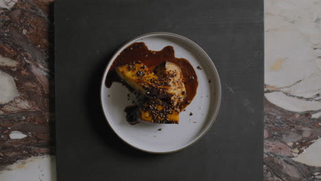 overhead shot of a chef plating a gourmet sweet potato dish in a restaurant