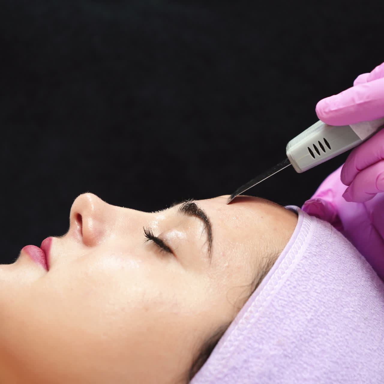 Ultrasonic cleaning of face in cosmetology salon. Cosmetic procedures for the face.