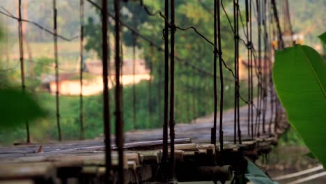 shot of vibration on the surface of the wooden suspension bridge in indonesia