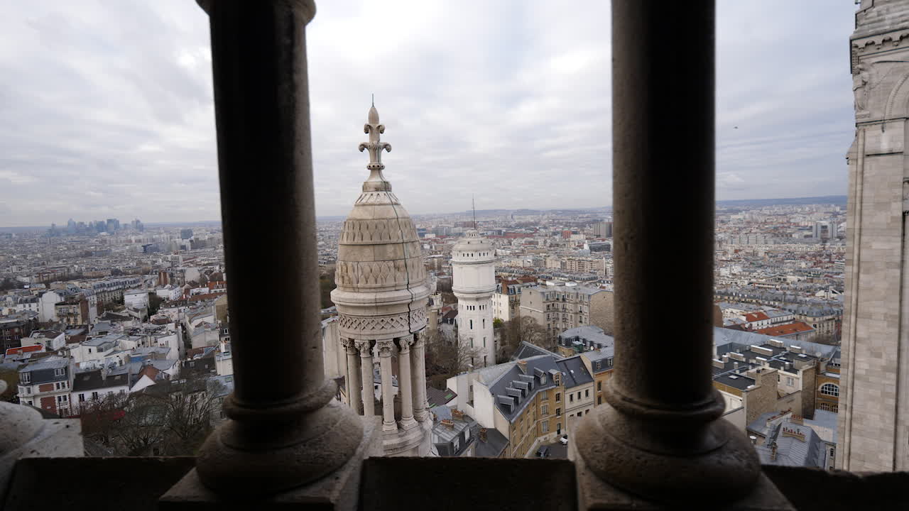 Spectacular view of Paris on a cloudy winter's day from the top of Sacre Coeur Basilica with pillars moving by in the foreground